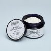 Moxie Tallow Butter, Vanilla Spice, open violet glass jar with its lid leaning against it