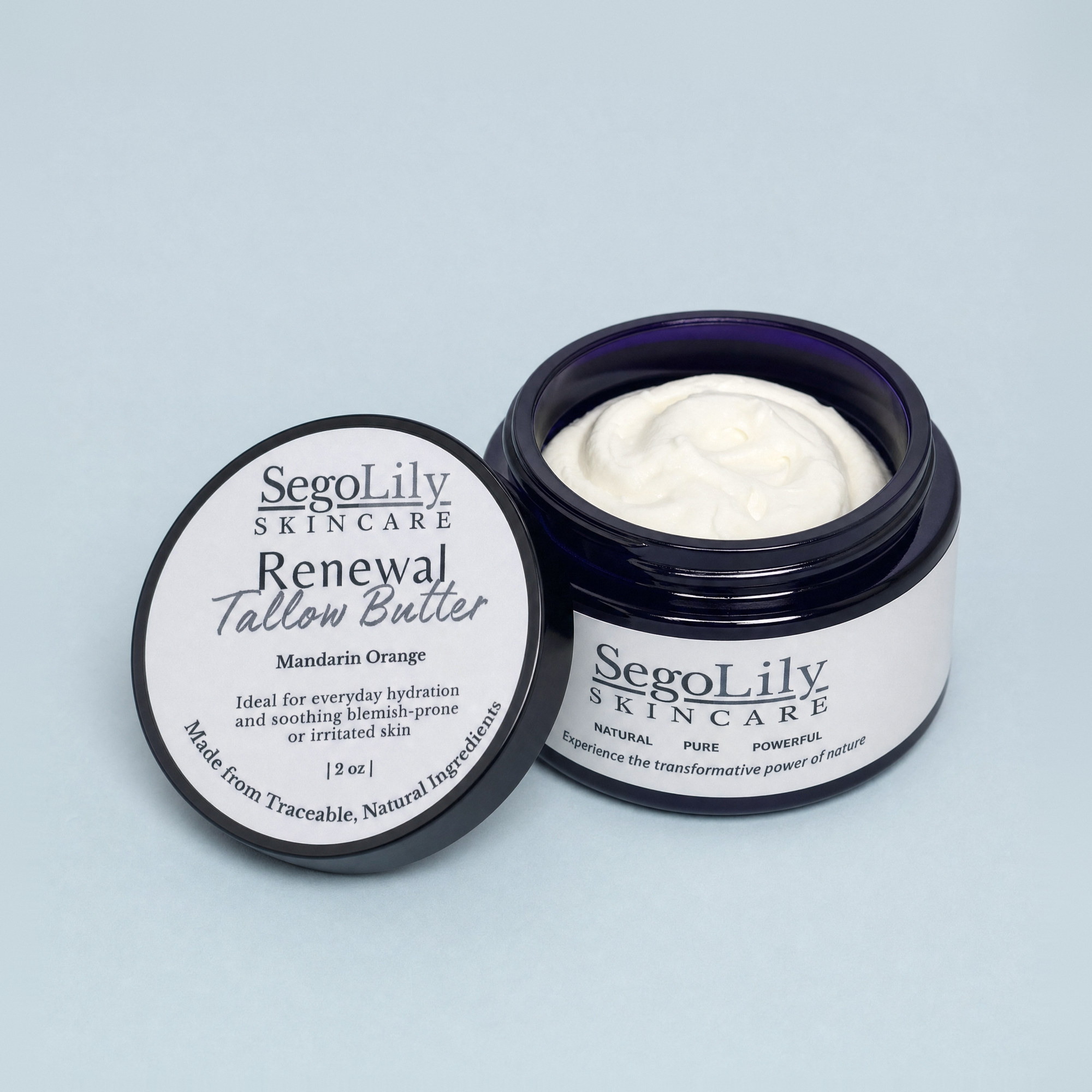 Renewal Tallow Butter, Mandarin Orange, open violet glass jar with its lid leaning against it